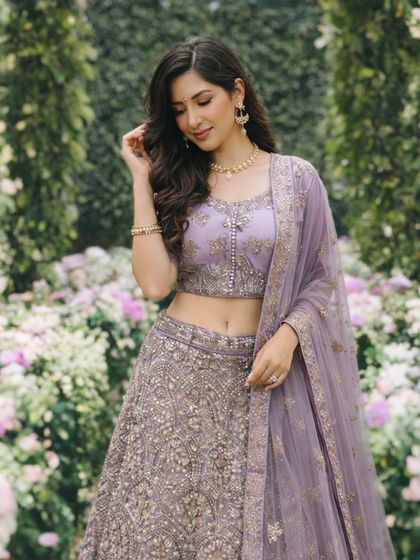 A closer look at the lavender lehenga, detailing the intricate silver embroidery on the blouse and the delicate net dupatta.