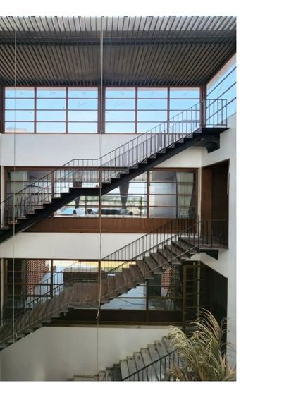 The central staircase of the 'Ishtika' project, a complex and beautiful circulation space that connects the different levels of the home.