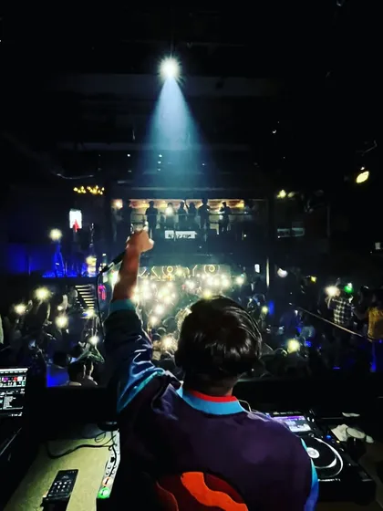 Creating a magical 'flashlights up' moment with the crowd. I love changing the vibe, from high-energy bangers to soulful singalongs, making sure the night has its own unique rhythm.