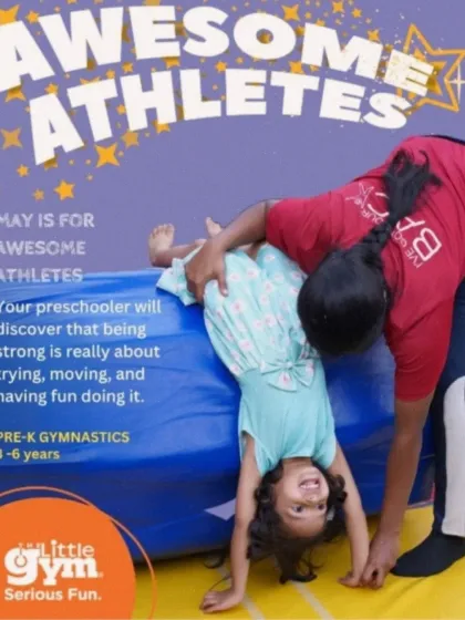 Our "Awesome Athletes" program is designed for preschoolers aged 3-6. Here, an instructor safely guides a smiling child through a forward roll, showing how we make learning foundational gymnastics skills a fun and encouraging experience.