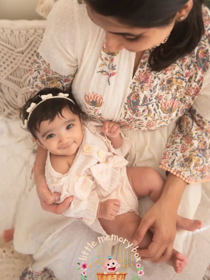 A mother's love is a beautiful thing to witness. This candid moment of a mum holding her baby is filled with so much warmth and affection.