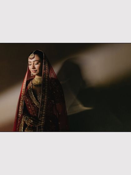 A classic bridal portrait of Nikita under a dramatic single light source. The play of light and shadow creates a timeless, painterly effect that is central to our artistic style.