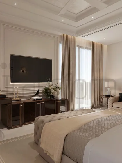 This bedroom is designed to be a reflection of the soul, graced with timeless elegance. The space includes a comfortable seating area and a dedicated workspace, all unified by a calm, neutral palette and classic wall paneling.