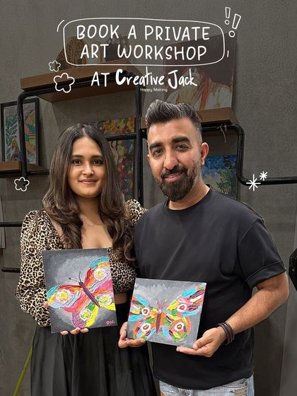 This couple proudly holds up their vibrant, abstract butterfly paintings. Each artwork is unique, reflecting the individual creativity they brought to their shared date.