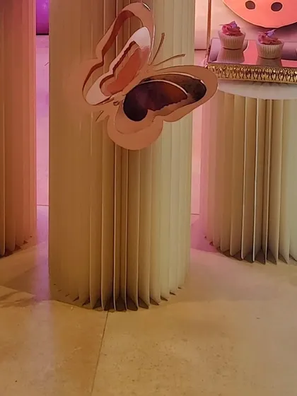 3D butterfly cutouts on the pedestals add depth and elegance to the overall party design.