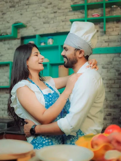 Love is cooking up something beautiful! This couple shares a laugh in a quirky kitchen setting, a perfect example of a themed pre-wedding shoot that reflects shared interests and creates fun, natural interactions.