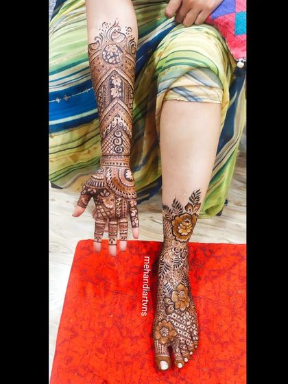 Showing one arm and one leg, this photo highlights how I create complementary, but not identical, designs for a balanced and artistic bridal look.