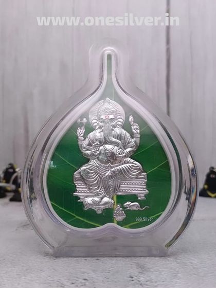 A unique Ganesha idol framed within a transparent pan-leaf shape, made with 999 pure silver. This modern design is a beautiful and auspicious gift.