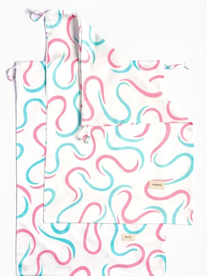A clean, flat lay of three patterned reusable pouches of different sizes against a stark white background. This simple presentation clearly shows the product's design and the variety available in the set.
