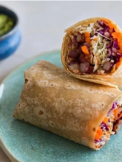 A closer look at my custom plate for EKA Whole Food Cafe, holding a delicious wrap. The subtle texture and color of the ceramic plate are designed to enhance, not overpower, the food it holds.