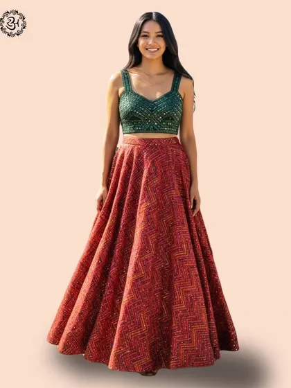 The model is pictured without the dupatta, showcasing the beautiful combination of the green mirror-work blouse and the red printed skirt.