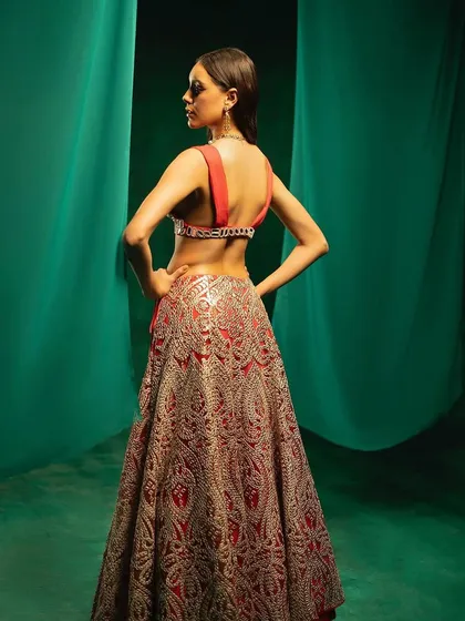 The back view of the red mirror-work lehenga from 29 India, showcasing the detailed embroidery and blouse design.