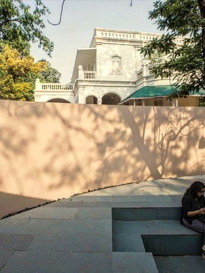 A student finds a quiet place to read on the steps of the sunken courtyard at the Kasturbhai Lalbhai Museum. We design these "in-between" spaces to be habitable and inviting, supporting both social and individual activities.