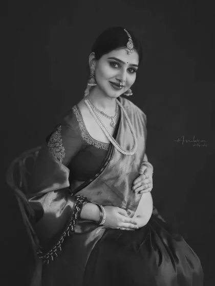 A black and white version of the portrait, emphasizing the emotion and timeless quality of the moment. The traditional attire and jewelry gain a new, classic dimension in monochrome.