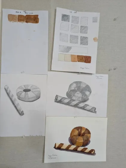 A display of student work from our object study class. These pieces show the progression from value studies to shaded pencil drawings and finally to full-color paintings.