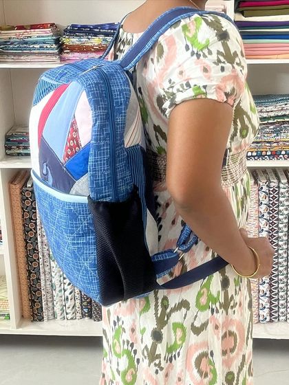 A student models the custom-made memory backpack, demonstrating its comfortable fit and practical size.