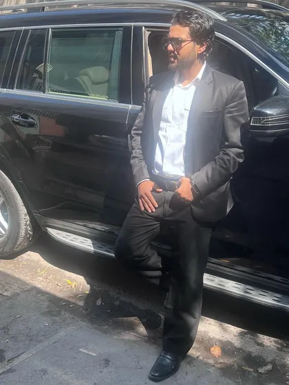 Taking a moment by my car. The rewards of hard work and successful outcomes are a great motivator.