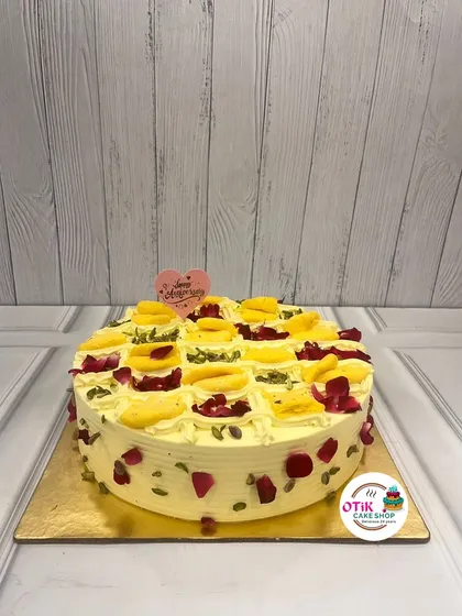 This is our much-loved Rasmalai Cake, a perfect example of our Indian fusion creations. We soak a soft, airy sponge in sweet, cardamom-infused milk and top it with delicate rasmalai pieces, pistachios, and rose petals for a truly decadent dessert.
