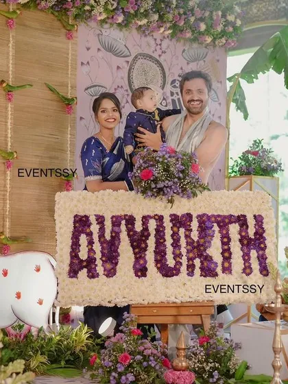 A heartwarming moment as the family poses for a photo at the naming ceremony. The decor serves as a beautiful and meaningful backdrop for capturing these precious family memories.