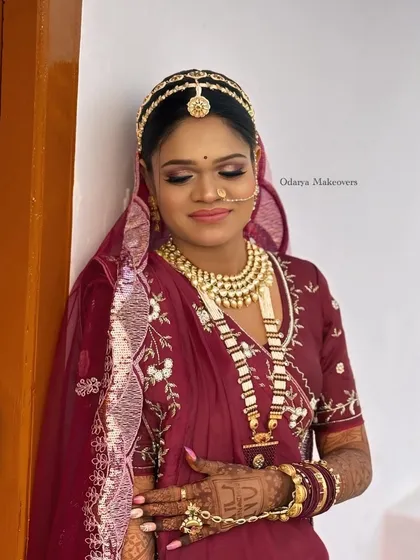 A serene moment captured. The soft, matte makeup with a hint of shimmer on the eyes ensures the bride looks elegant and timeless in her wedding photos.