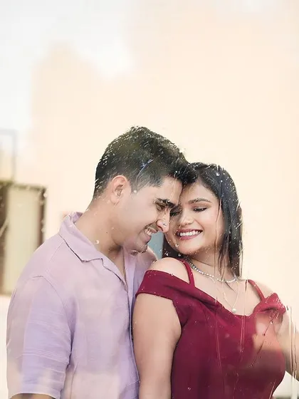A creative shot of a couple behind a rain-swept window. Our sets allow for artistic effects like this to add a unique, romantic touch to your pre-wedding photos.