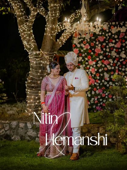 A romantic nighttime portrait. The fairy lights on the tree create a magical, sparkling backdrop for this intimate moment between the couple.