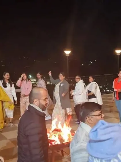 A candid moment of joy and community around a bonfire during our Himachal retreat.