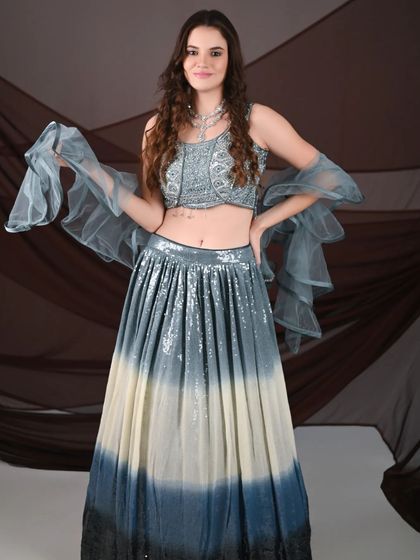 This international model is wearing a beautiful grey ombre lehenga with sequin work and a ruffled dupatta. My outfits are perfect for creating diverse and high-fashion portfolio looks.