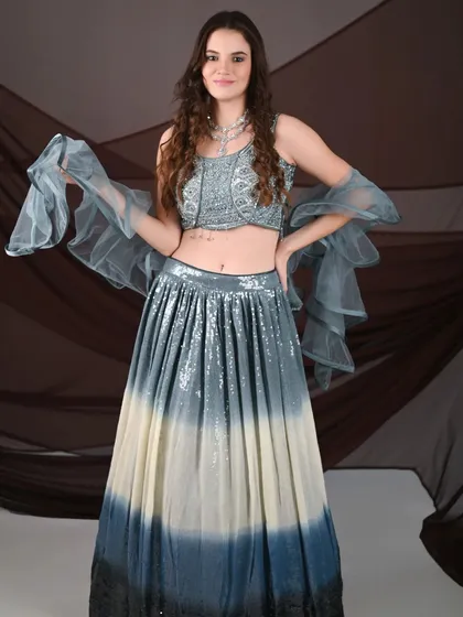 A full-length shot of the model in the ombre lehenga, showing its complete, dramatic effect.