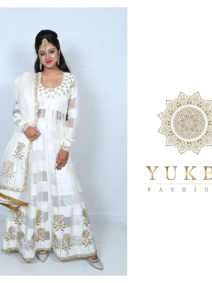 A full frontal view of the white and gold block-printed Anarkali, showing its elegant and regal design.