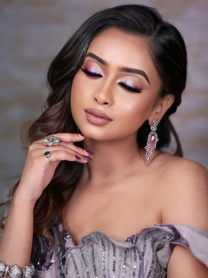 A close-up from a mobile photography class, showing a holographic, colorful eyeliner look paired with modern, artistic earrings.
