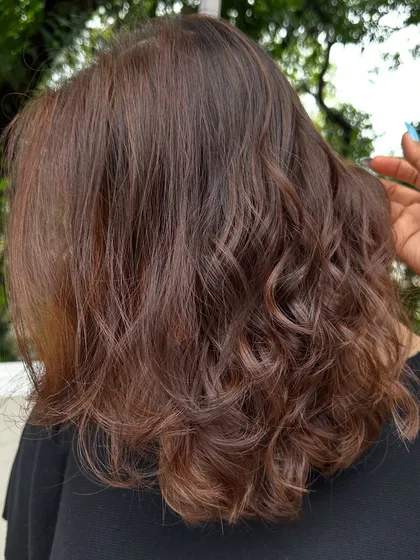 This 'Cinnamon Chocolate' color is perfect for adding warmth and spice to dark hair. The cinnamon tones really pop against the deep chocolate base, especially when styled with waves.