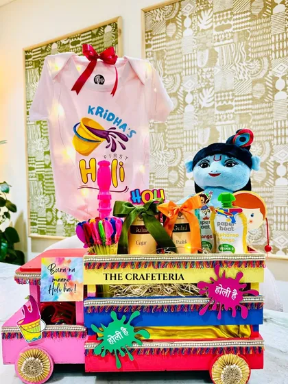 Celebrating a baby's first Holi with a splash of color! This vibrant, truck-shaped hamper is filled with organic colors, a personalized onesie, and playful surprises.