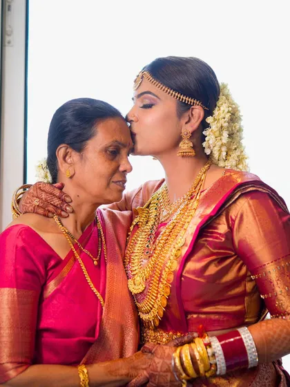 A touching moment between the bride and her mother. Her makeup is minimal and magical, proving you don't need heavy layers to look radiant on your big day.