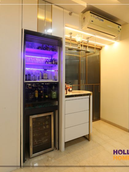 The hidden bar cabinet opens up to reveal a fully stocked bar with a mini-fridge and dramatic purple lighting, adding an element of surprise and luxury.