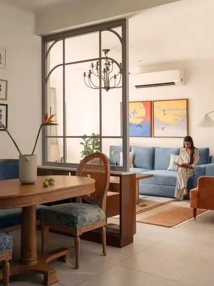 To create a sense of separation without sacrificing light, I installed a glass and metal partition between the dining and living areas. This defines the two zones while maintaining an open, airy feel perfect for entertaining.