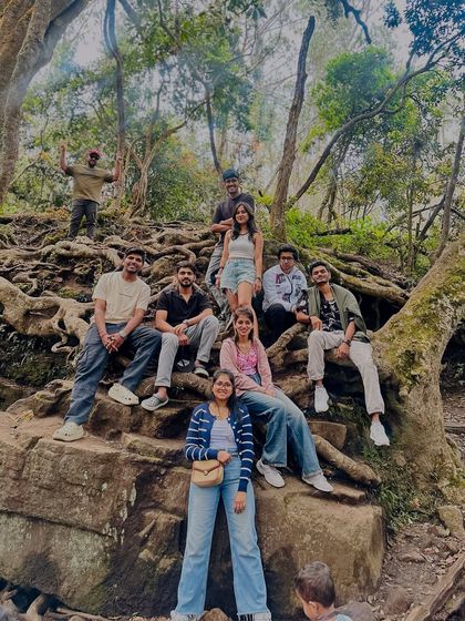 Finding the perfect spot to relax and take a group photo amidst the rocky, root-covered trails.