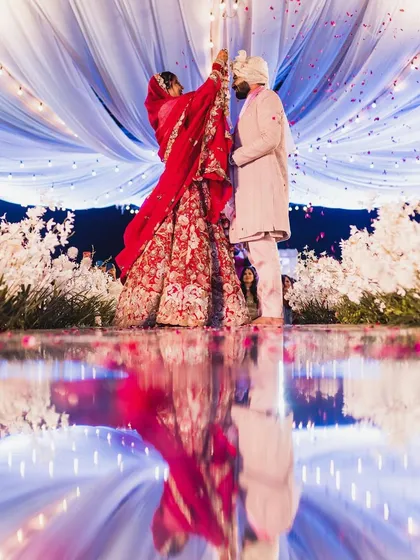 The jaimala ceremony. The reflection on the floor, the flowers, the lights, it was all a dream. My red lehenga was perfect for the traditional ceremony.