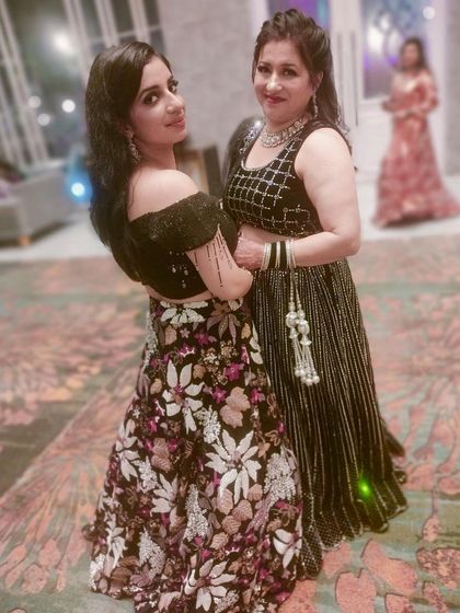 A beautiful mother-daughter duo. The daughter is wearing the popular black floral rental lehenga, showing how versatile and loved this piece is.