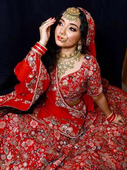 A close-up of our stunning red bridal lehenga. The detailed embroidery and craftsmanship are what make our outfits special.