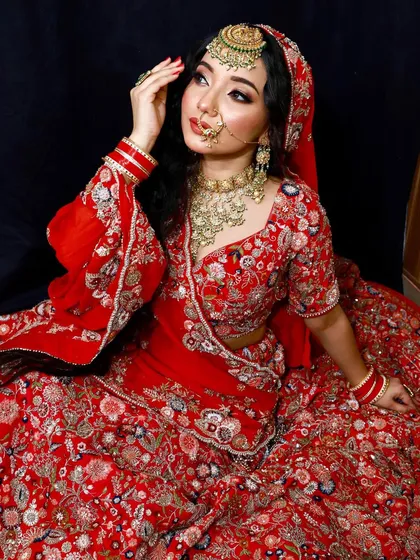 A stunning red bridal lehenga, perfect for the traditional bride. The intricate floral embroidery is a work of art.