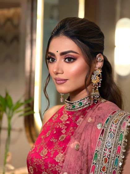 A side profile of the mehendi look. The soft, romantic hairstyle complements the makeup perfectly.