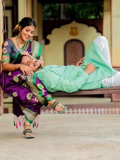 A relaxed and affectionate pose that feels natural and intimate. This composition beautifully showcases their comfort and connection in a culturally rich setting.