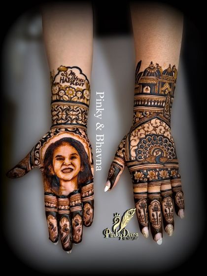 A full view of a special Mundan ceremony mehndi. The left hand proudly displays a smiling portrait of the child, while the right hand is adorned with traditional motifs, blending personal love with timeless art.