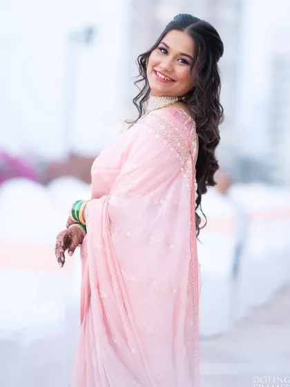 A side profile showing off her soft, cascading curls, a perfect hairstyle for a reception party.
