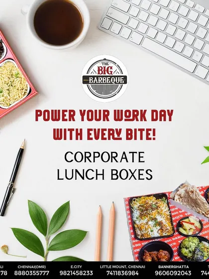 Power your team's workday with our corporate lunch boxes. This top-down view shows a complete, well-balanced meal with starters, main course, bread, and dessert, neatly packed and ready for office delivery.