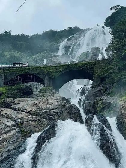 The iconic railway bridge at Dudhsagar Falls, a view that never fails to amaze. Join our weekend treks to see it for yourself.