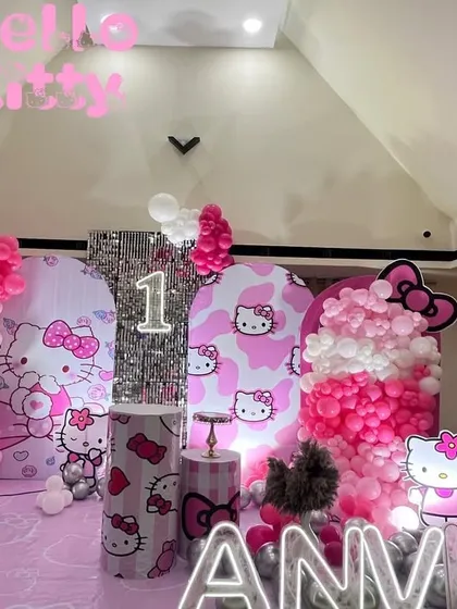 A full view of the Hello Kitty themed birthday decoration. This shows the complete stage with themed backdrops, balloon arrangements, and props creating a perfect photo opportunity.
