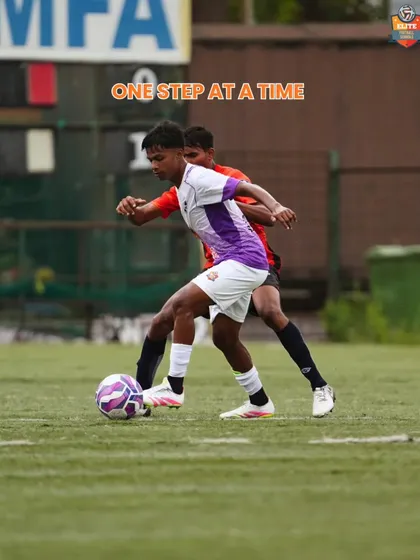 "One Step at a Time." A player shields the ball under pressure, showing the strength and composure we build in our athletes.
