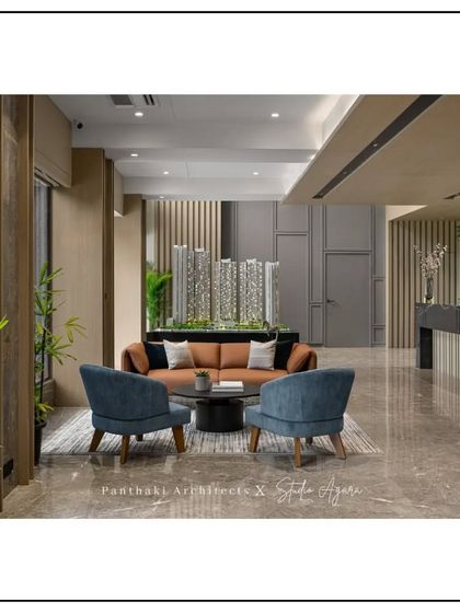 This lobby features a central seating arrangement and a striking green wall, immediately signaling a company culture that values both collaboration and well-being.